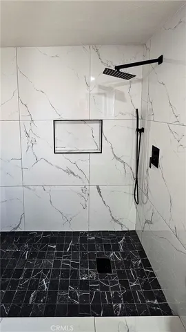 a kitchen with a refrigerator and white cabinets