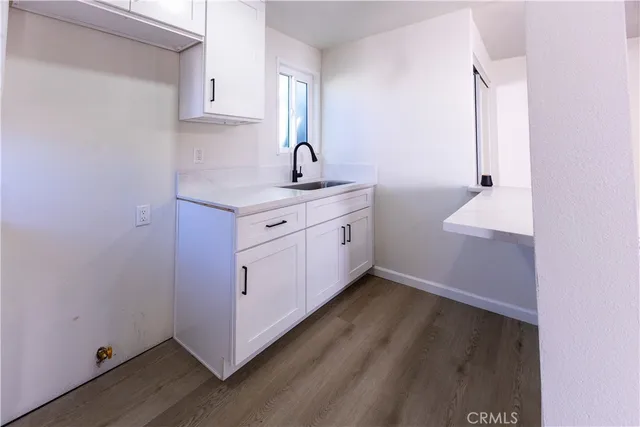 a view of kitchen and wooden floor