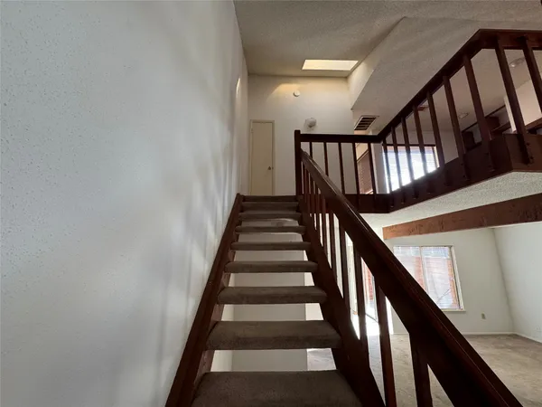a view of entryway livingroom and hall with wooden floor