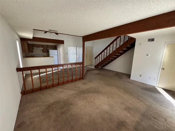 a bathroom with a granite countertop bathtub shower sink vanity and toilet