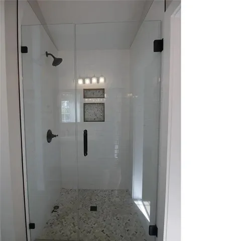 a bathroom with a bathtub and shower
