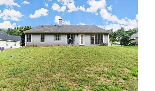 a view of a big yard with large trees