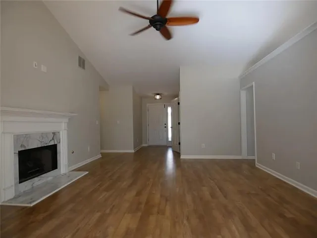 wooden floor in an empty room with a fireplace