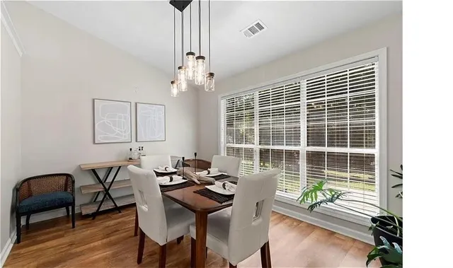 a view of a dining room with furniture window and wooden floor