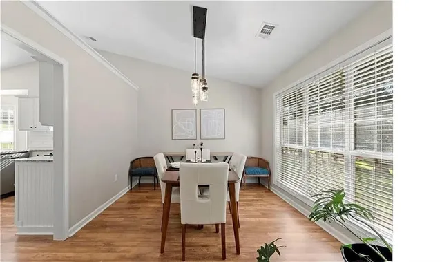 a view of a dining room with furniture window and wooden floor