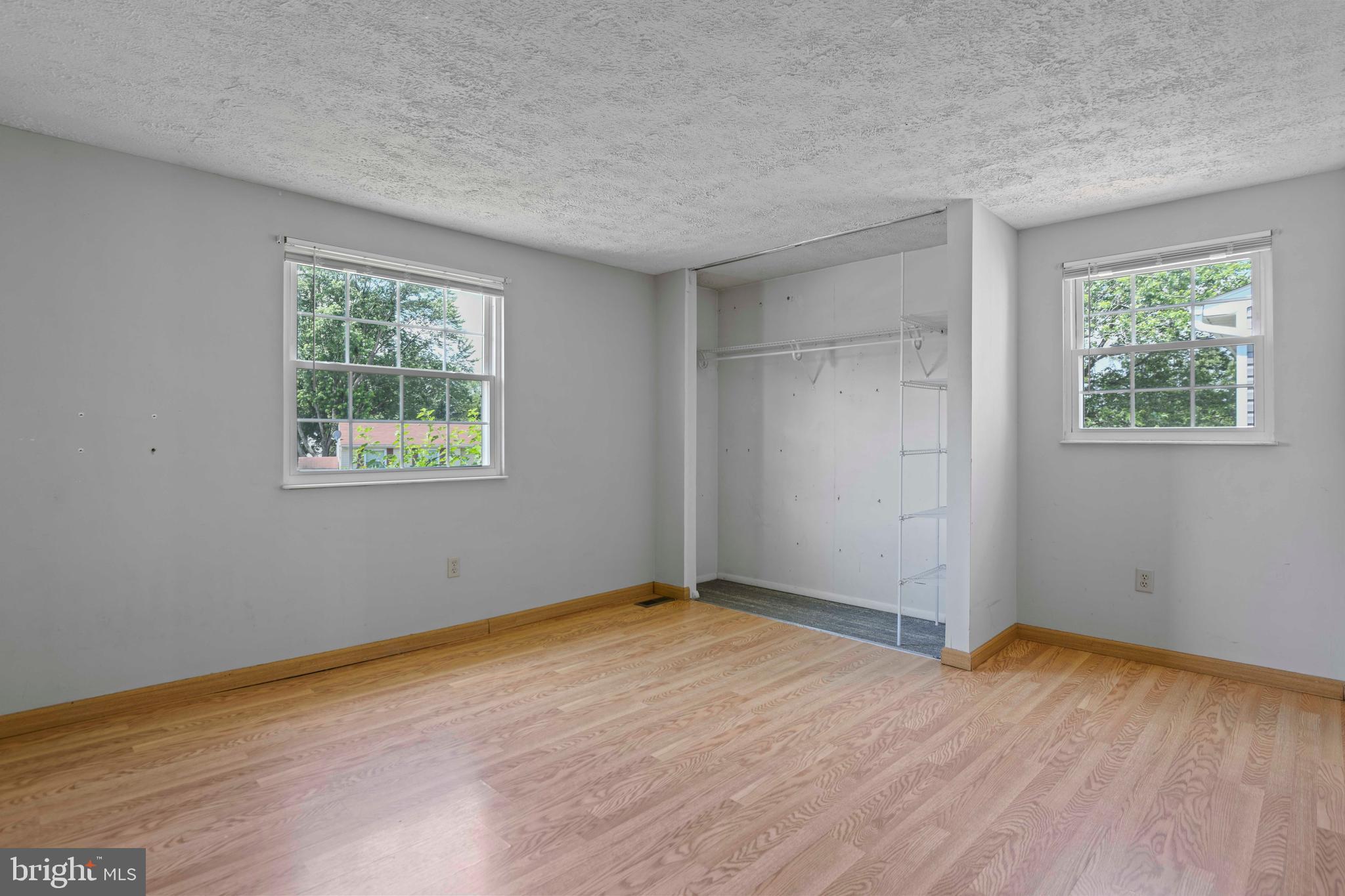 1824 Lawnview Drive Frederick, MD 21702 - Photo 11 of 21 an empty room with wooden floor and windows