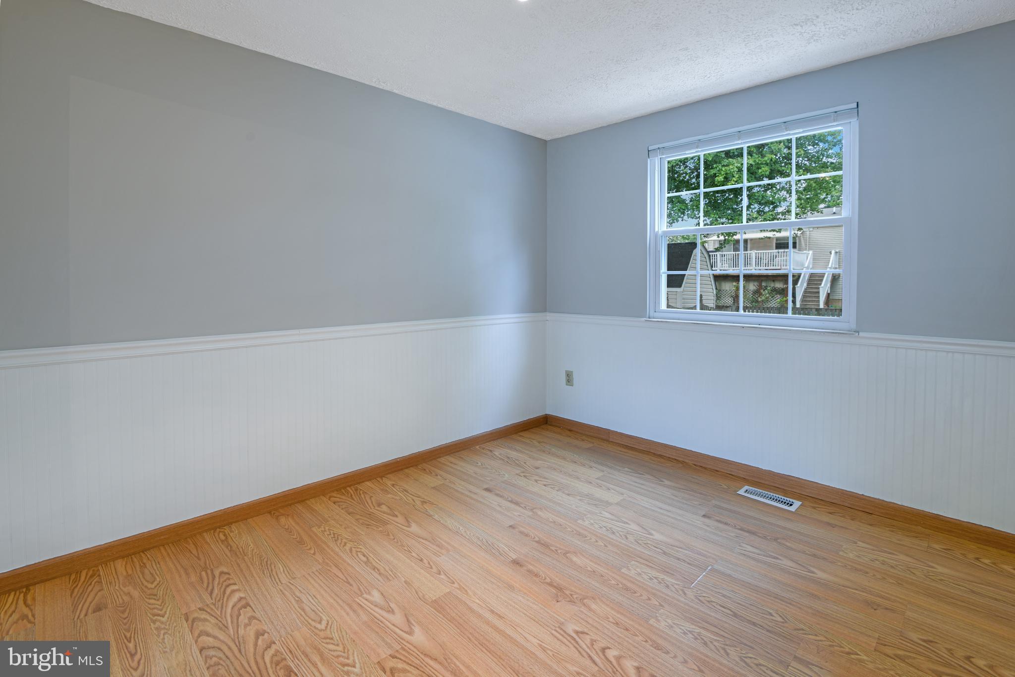 1824 Lawnview Drive Frederick, MD 21702 - Photo 4 of 21 a view of an empty room with wooden floor and a window