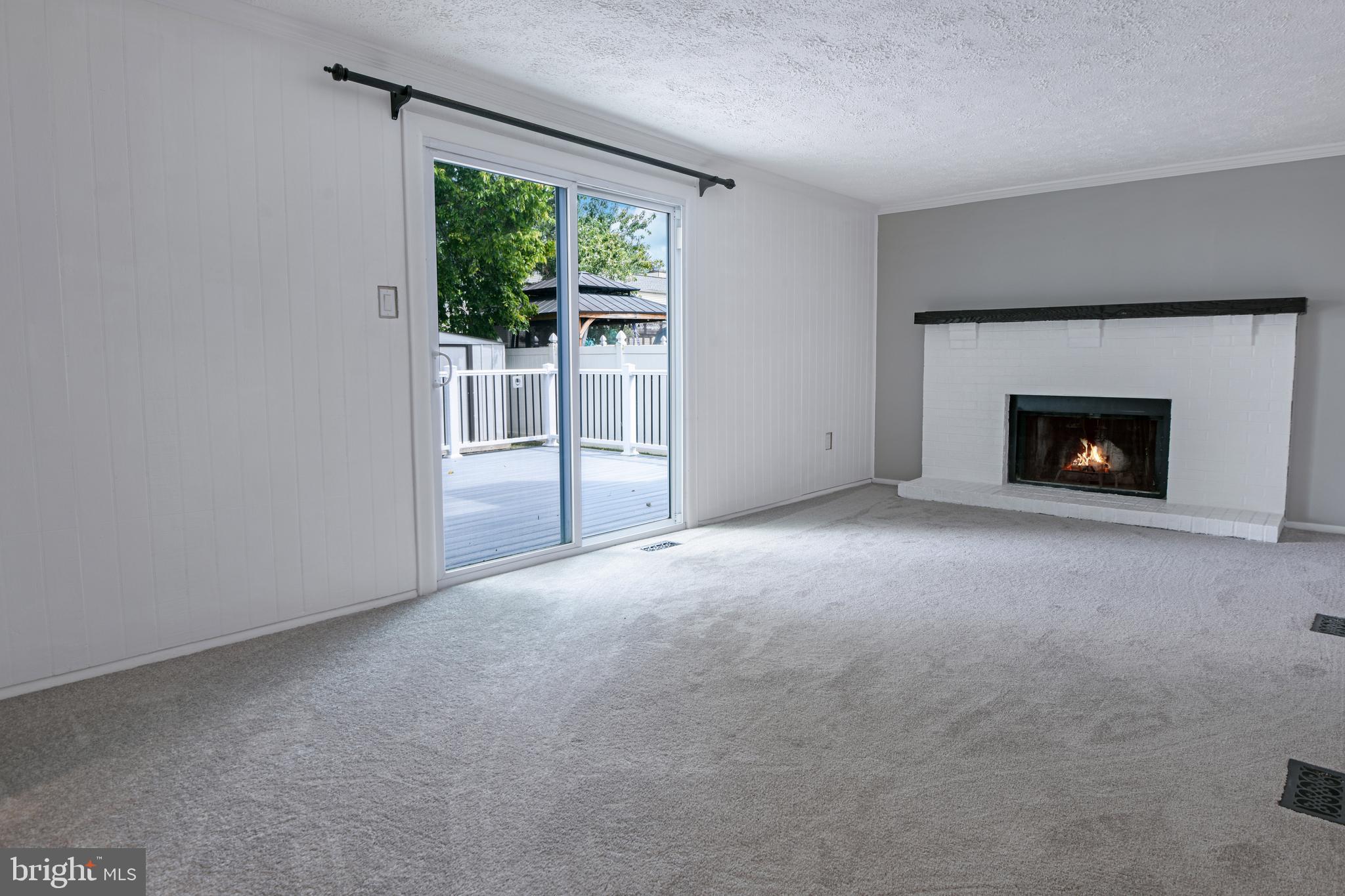1824 Lawnview Drive Frederick, MD 21702 - Photo 6 of 21 a view of an empty room with wooden floor fireplace and a window