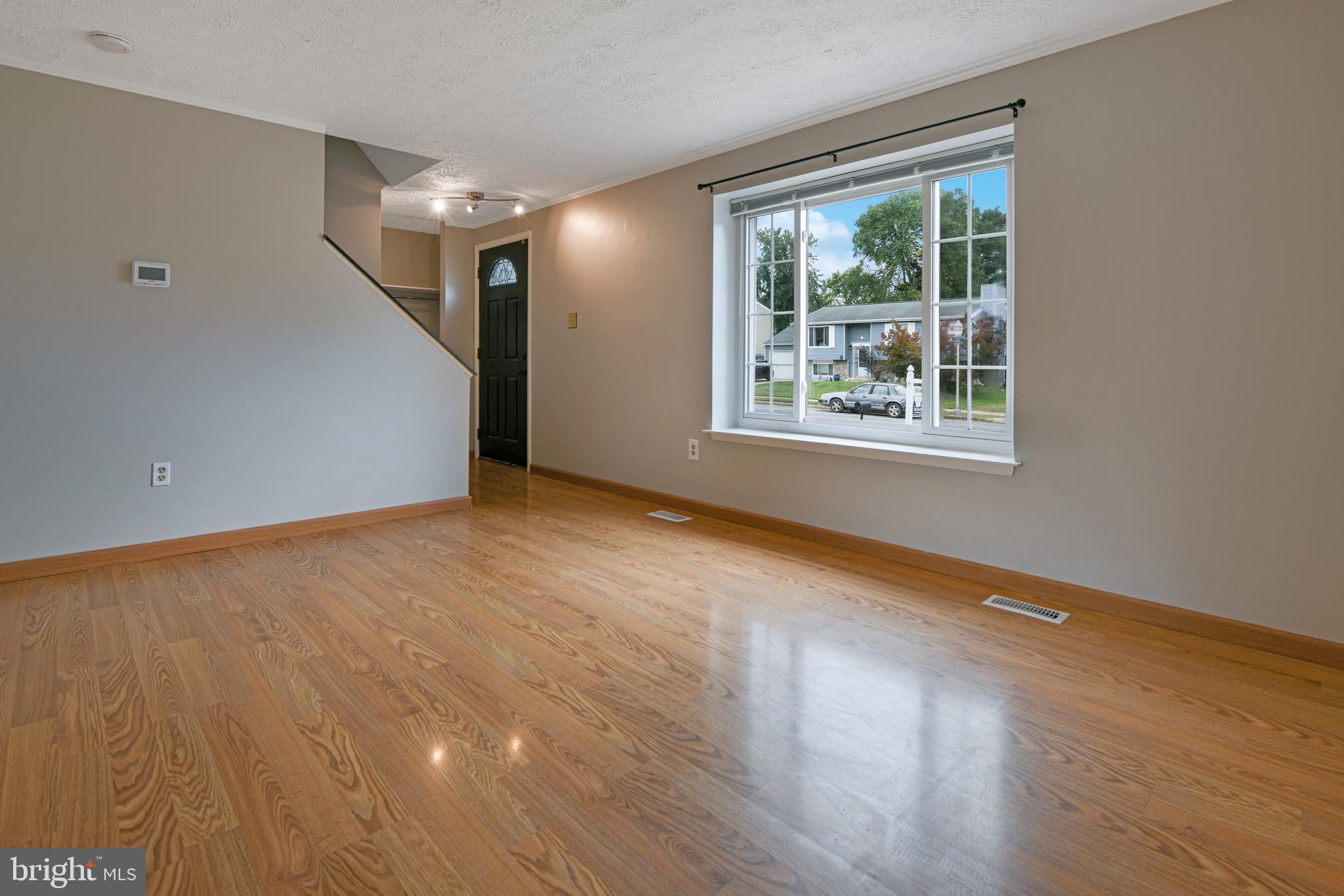 1824 Lawnview Drive Frederick, MD 21702 - Photo 7 of 21 a view of an empty room with wooden floor and a window