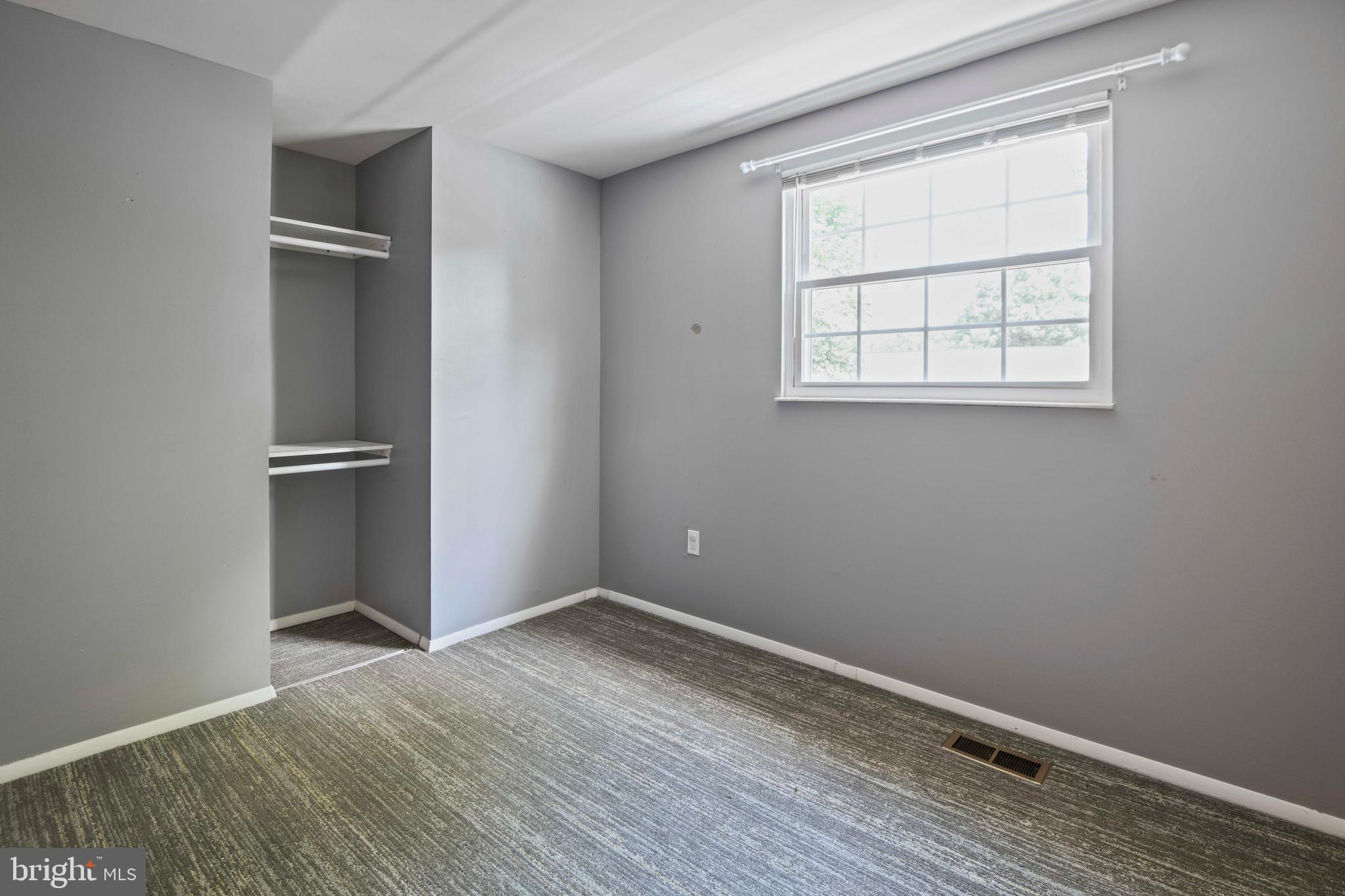 1824 Lawnview Drive Frederick, MD 21702 - Photo 8 of 21 an empty room with a window and wooden floor
