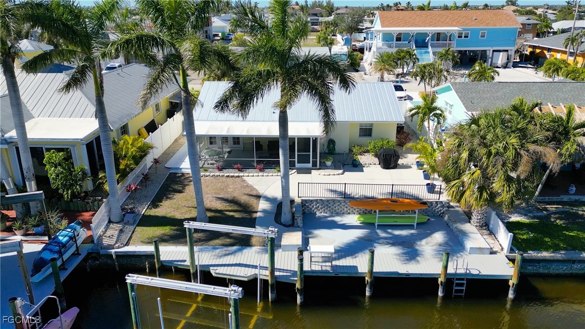 a view of swimming pool with outdoor seating and a lots of palm trees