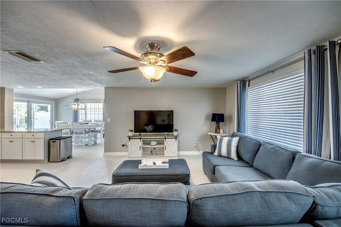 12262 Boat Shell Drive Matlacha Isles, FL 33991 - Photo 14 of 39 a living room with furniture flat screen tv and couches