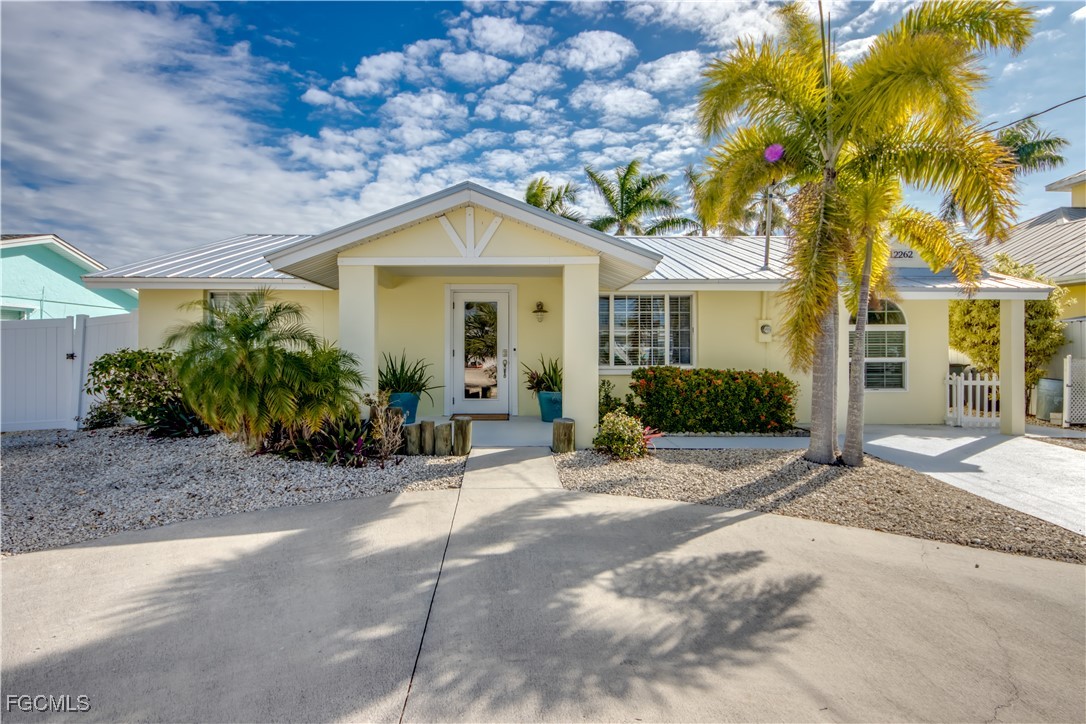 12262 Boat Shell Drive Matlacha Isles, FL 33991 - Photo 2 of 39 a front view of a house with a garden