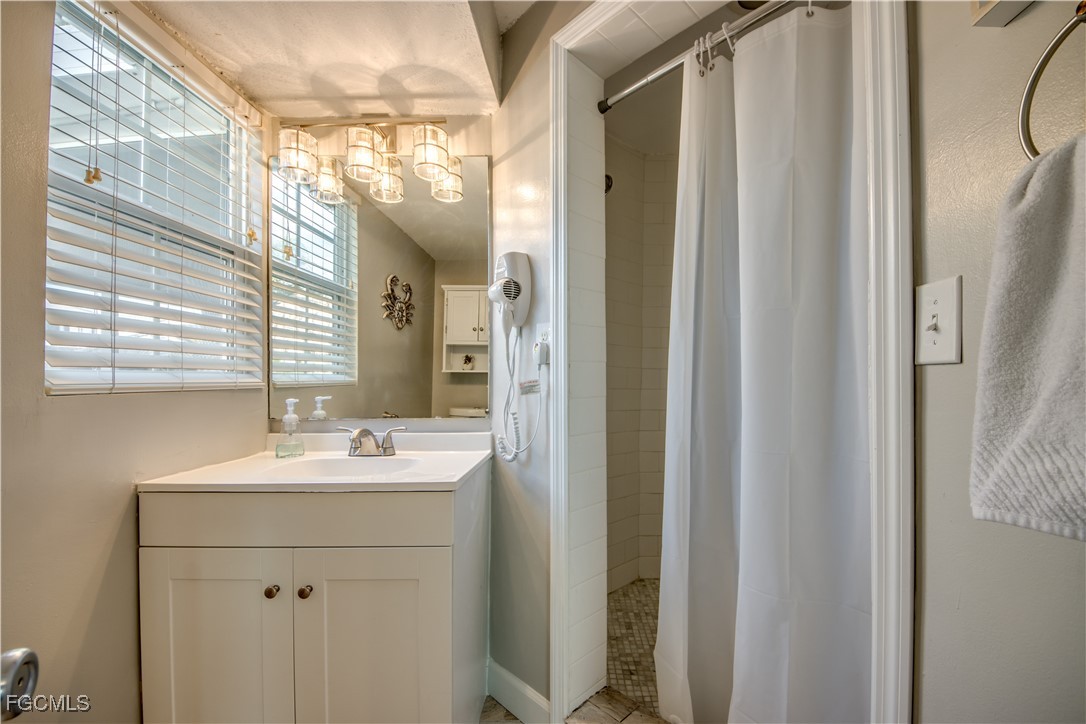 12262 Boat Shell Drive Matlacha Isles, FL 33991 - Photo 24 of 39 a bathroom with a sink mirror and a shower