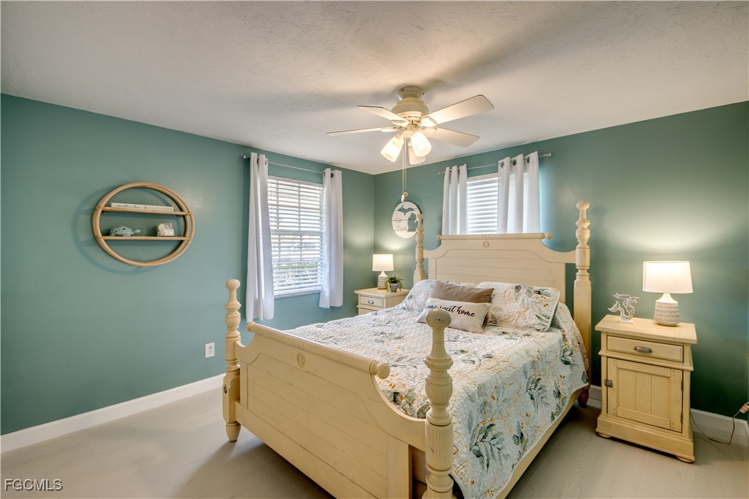 12262 Boat Shell Drive Matlacha Isles, FL 33991 - Photo 25 of 39 a bedroom with a bed and a chandelier