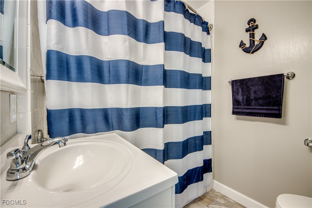 12262 Boat Shell Drive Matlacha Isles, FL 33991 - Photo 27 of 39 a bathroom with a sink and a mirror
