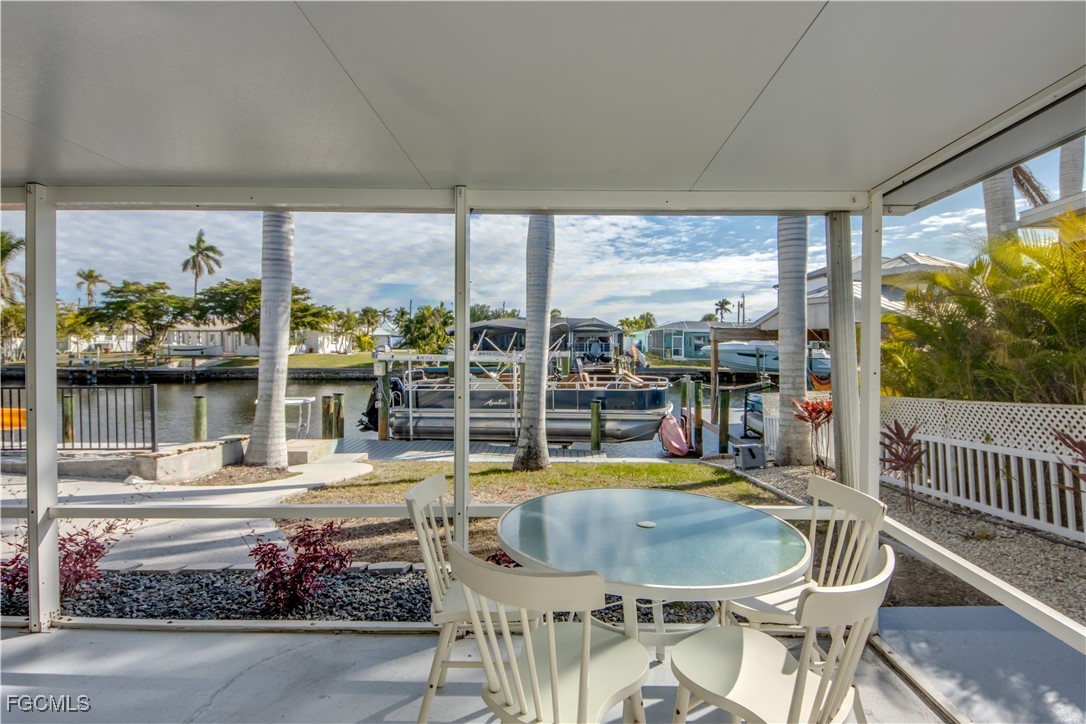 12262 Boat Shell Drive Matlacha Isles, FL 33991 - Photo 29 of 39 a dining room with furniture and a floor to ceiling window