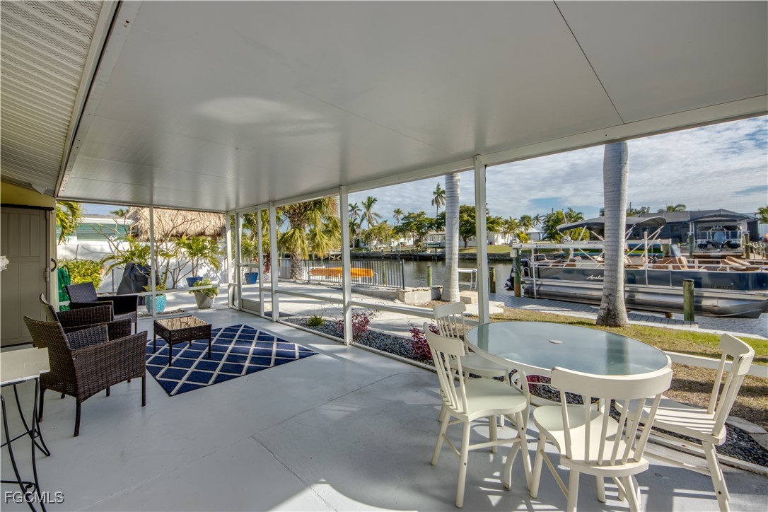 12262 Boat Shell Drive Matlacha Isles, FL 33991 - Photo 30 of 39 a outdoor space with a large window and white couches