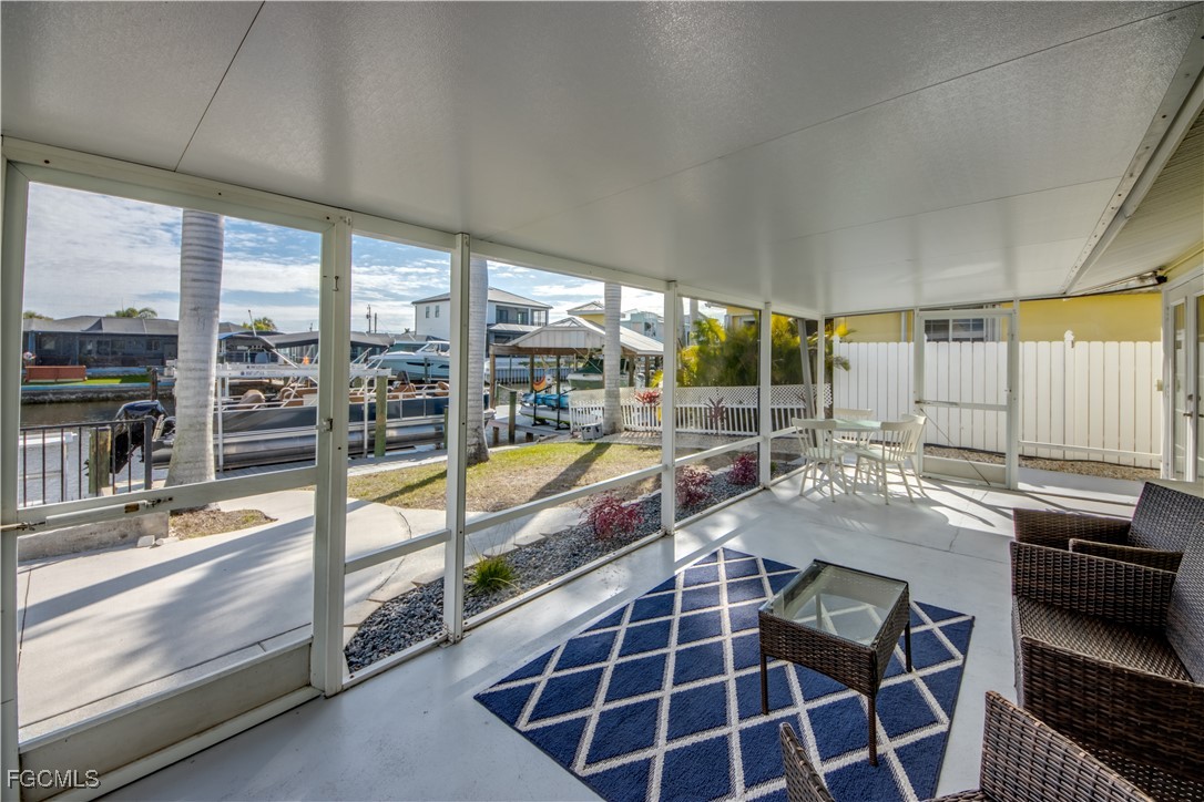 12262 Boat Shell Drive Matlacha Isles, FL 33991 - Photo 32 of 39 a view of a living room and kitchen with a large window