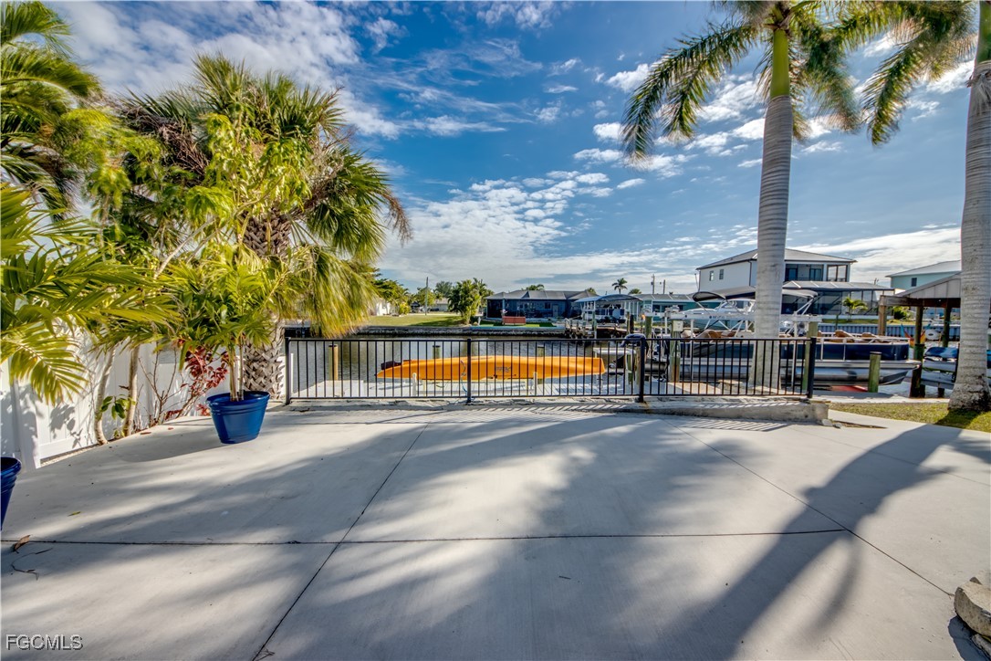 12262 Boat Shell Drive Matlacha Isles, FL 33991 - Photo 37 of 39 a view of a swimming pool with a lawn chairs under an umbrella