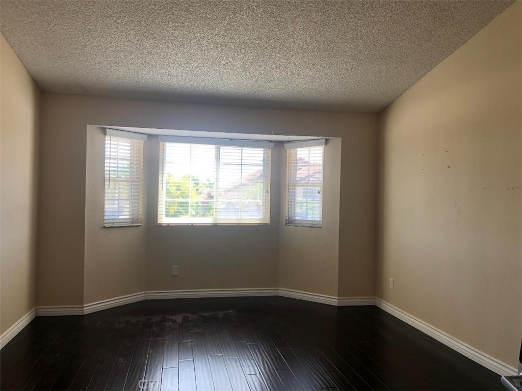 957 Silvertip Drive Diamond Bar, CA 91765 - Photo 7 of 14 an empty room with wooden floor and windows