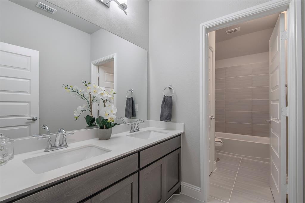16650 Nightshade Road Frisco, TX 75033 - Photo 30 of 40 a bathroom with a sink and a mirror