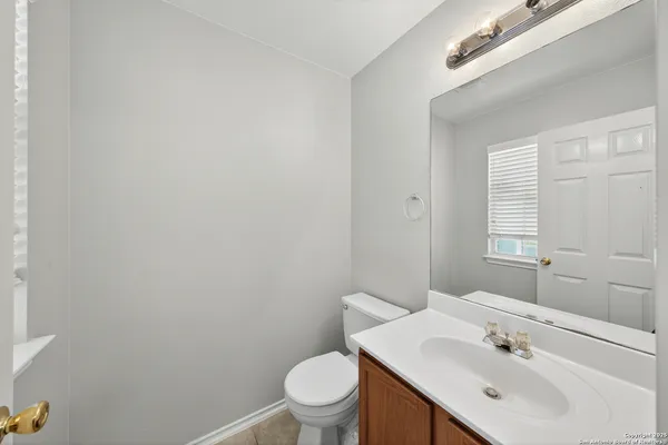 a bathroom with a sink a toilet and a mirror