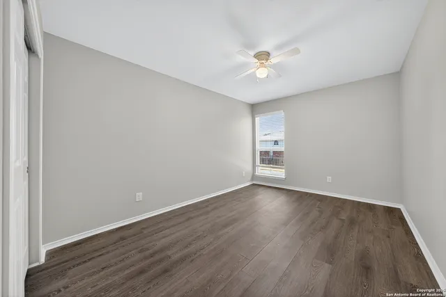 a bathroom with a bathtub shower sink vanity mirror and toilet