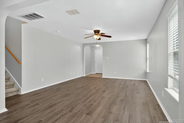wooden floor in an empty room with a window