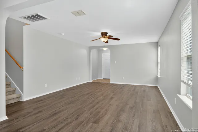 wooden floor in an empty room with a window