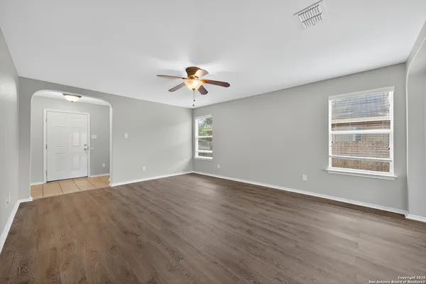 wooden floor in an empty room with a window