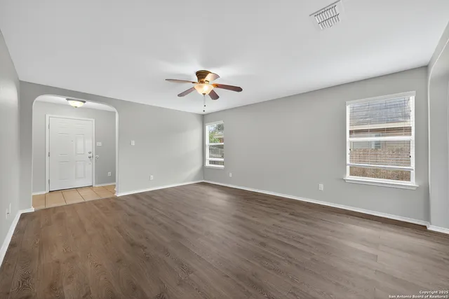 wooden floor in an empty room with a window