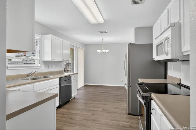 a kitchen with stainless steel appliances granite countertop a stove and a refrigerator