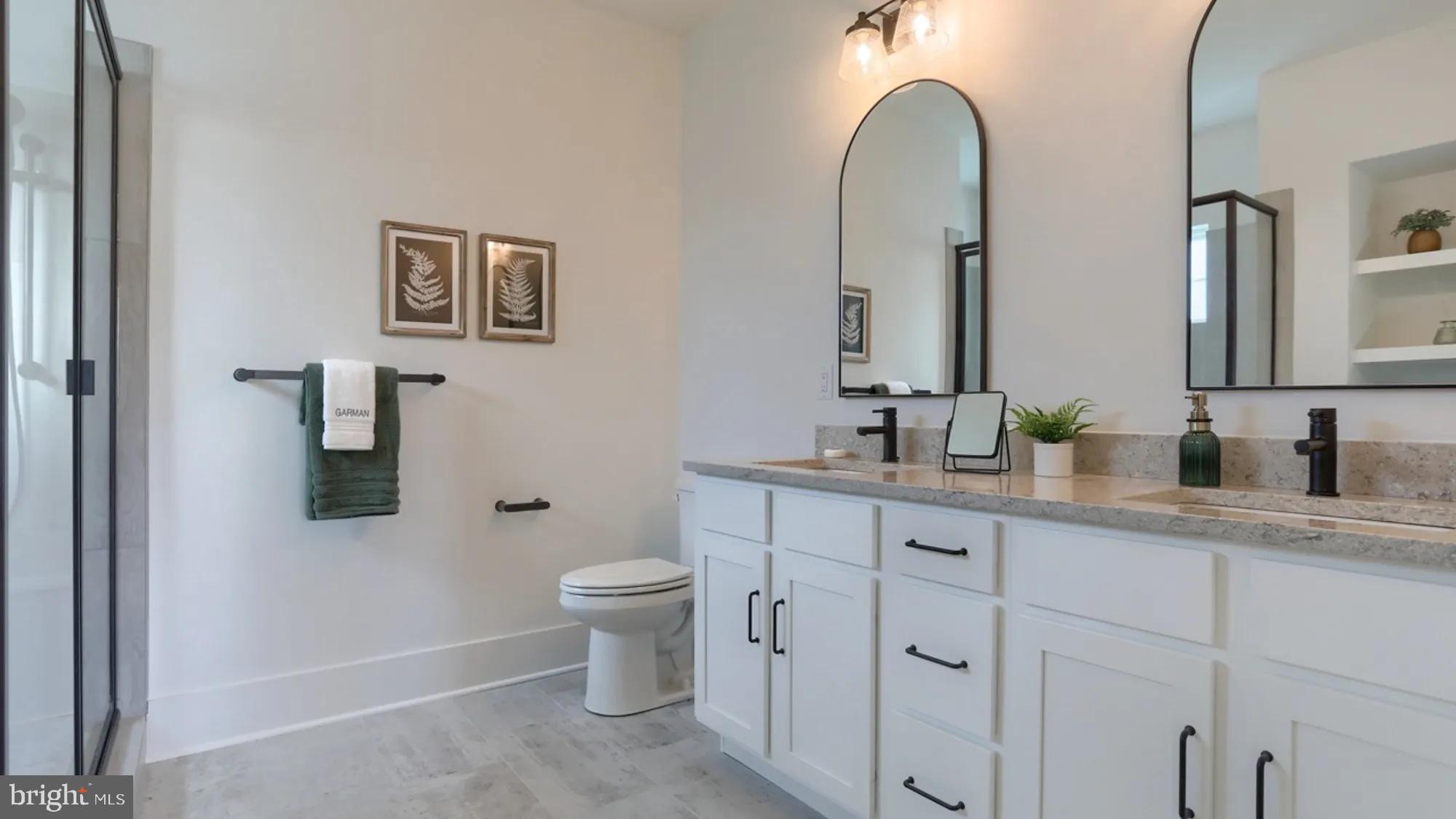 100 Flora Boulevard Lebanon, PA 17042 - Photo 17 of 24 a bathroom with double vanity sink a toilet and a mirror