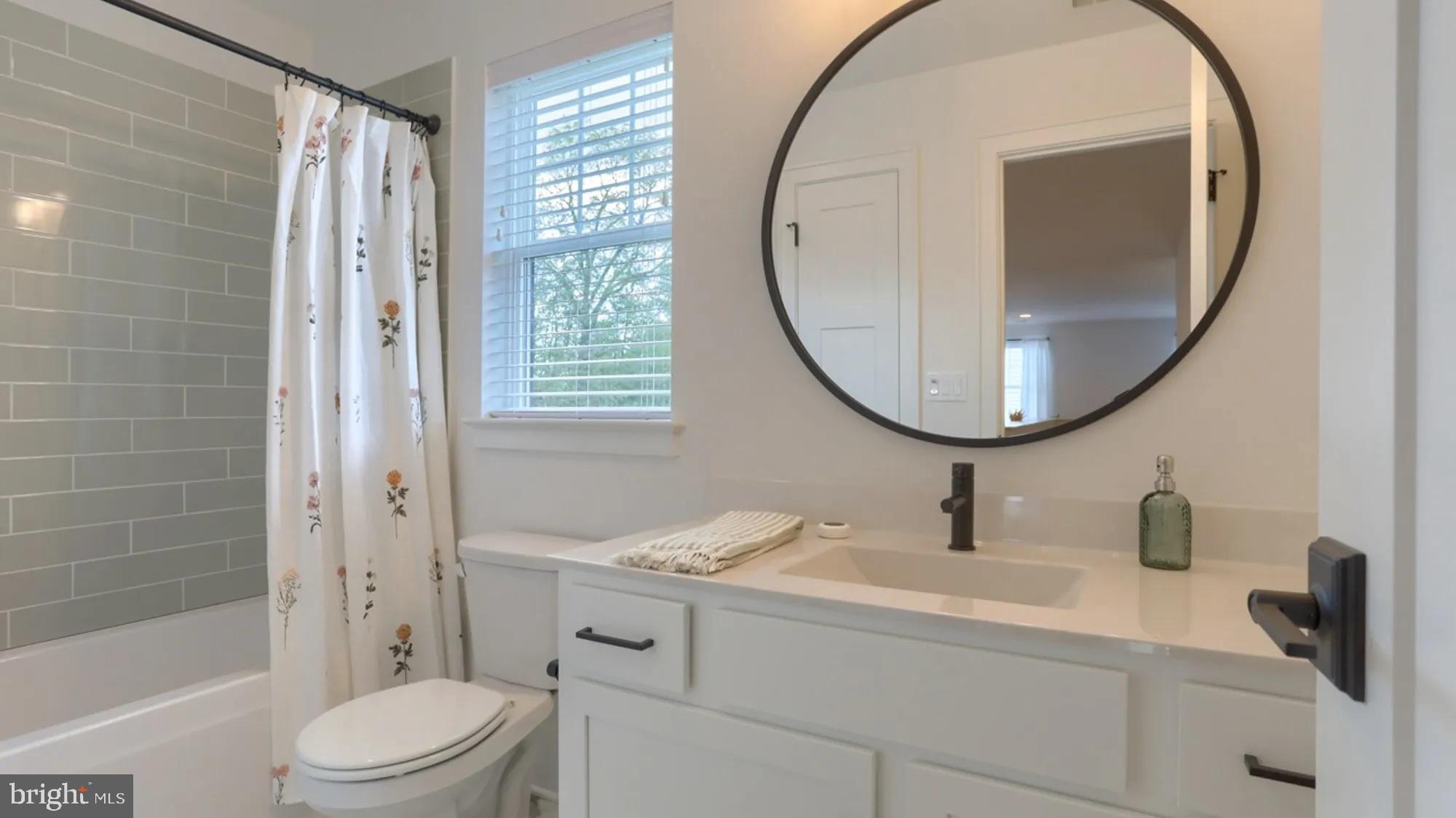 100 Flora Boulevard Lebanon, PA 17042 - Photo 21 of 24 a bathroom with a sink a toilet a mirror and a tub