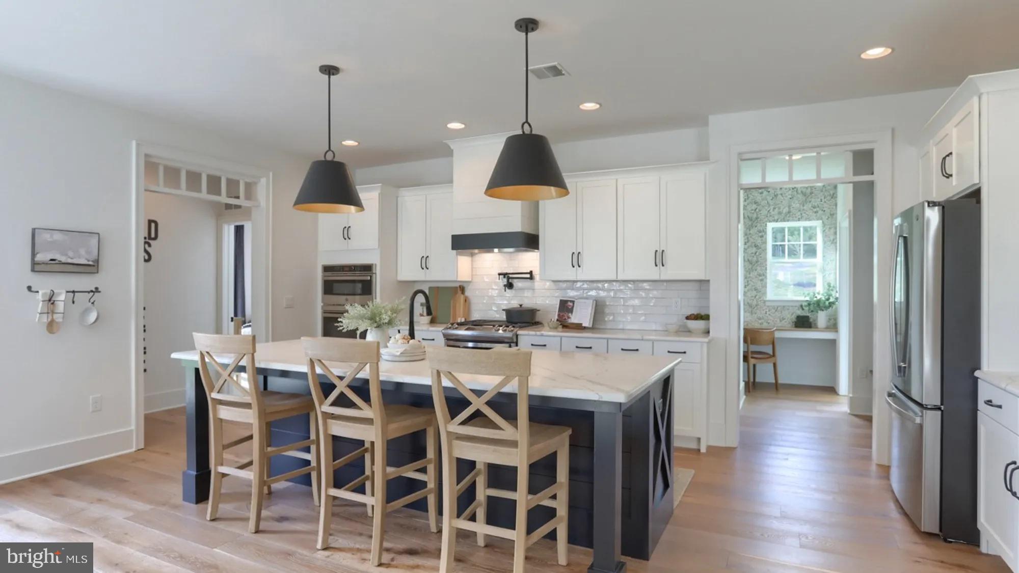 100 Flora Boulevard Lebanon, PA 17042 - Photo 7 of 24 a large kitchen with dining table stainless steel appliances and wooden floor