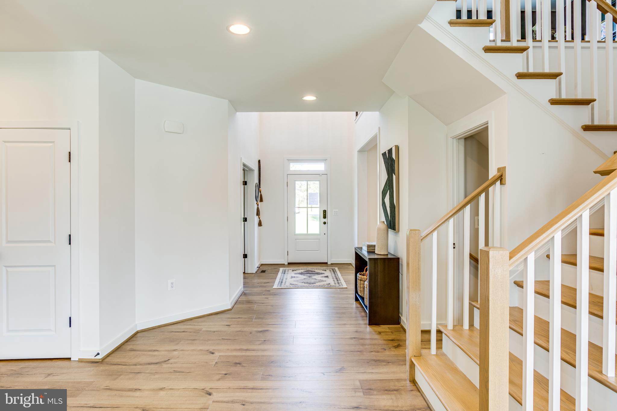 9 Burwell Road Nokesville, VA 20181 - Photo 28 of 61 a view of a hallway with wooden floor and staircase