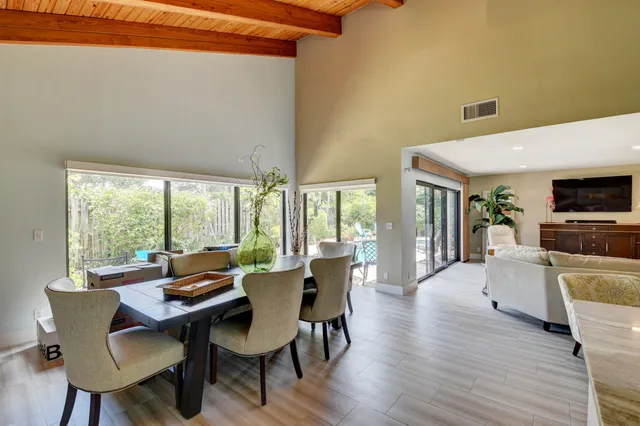 a dining room with furniture window and wooden floor