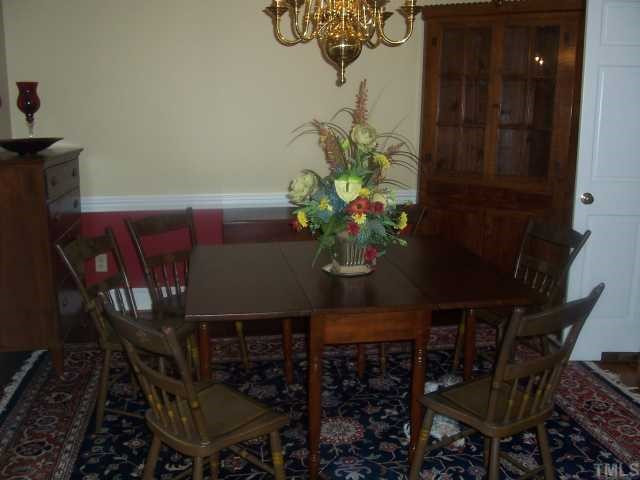 7909 Sutterton Court Raleigh, NC 27615 - Photo 3 of 12 Dining Room has 9' Smooth Ceiling, Pine Floors, Chairrail and Crown Molding -- Perfect for entertaining your very best friends. Dining Room