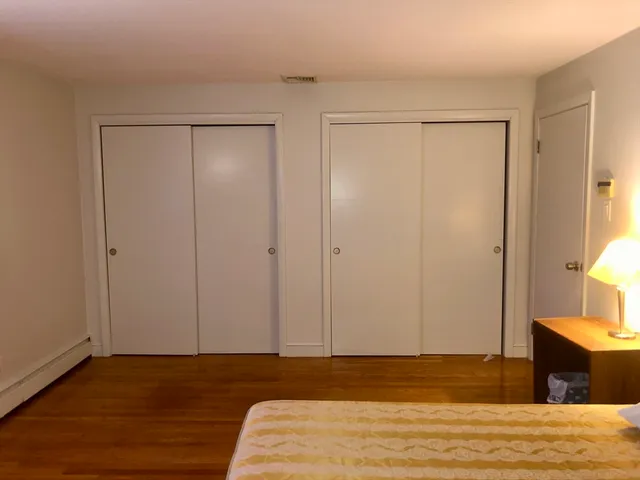 a view of a room with wooden floor and closet