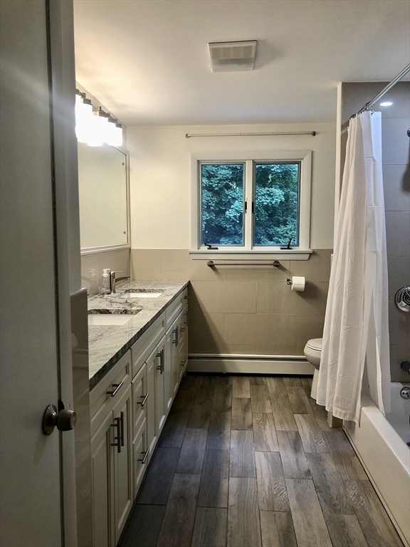 15 Sycamore Road Wakefield, MA 01880 - Photo 13 of 39 a bathroom with a granite countertop sink toilet and a large mirror
