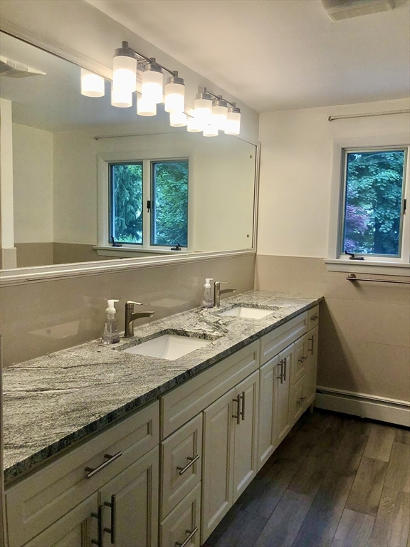 15 Sycamore Road Wakefield, MA 01880 - Photo 14 of 39 a bathroom with a granite countertop sink and a large mirror