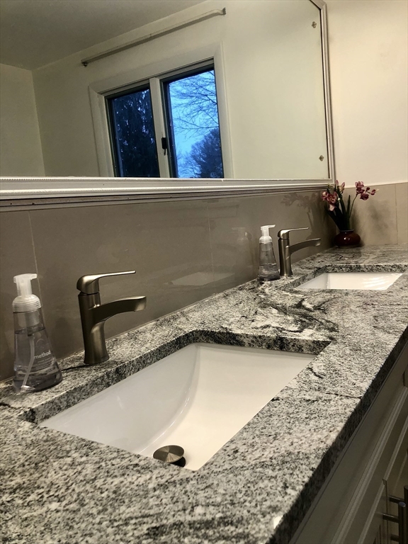 15 Sycamore Road Wakefield, MA 01880 - Photo 15 of 39 a bathroom with a granite countertop sink and a mirror