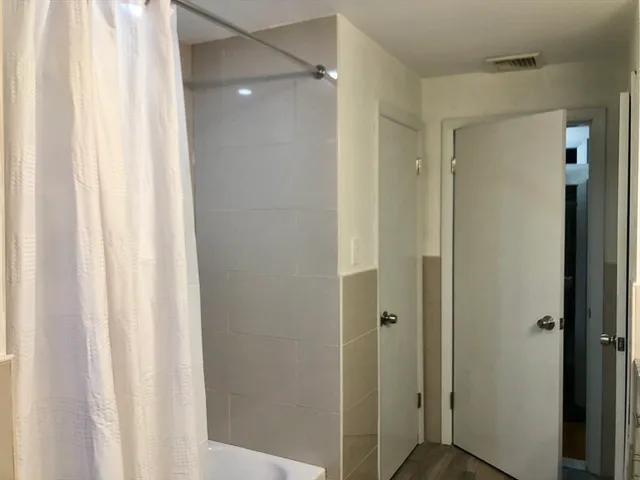 a bathroom with a shower and a curtain