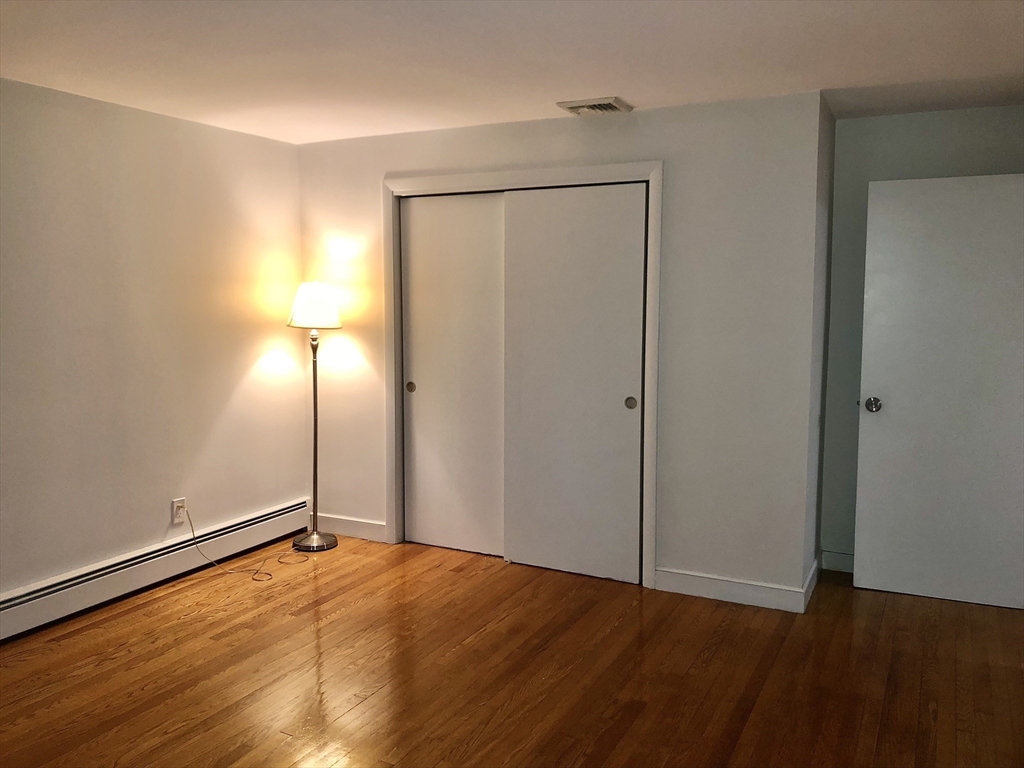 15 Sycamore Road Wakefield, MA 01880 - Photo 18 of 39 a view of an empty room with wooden floor