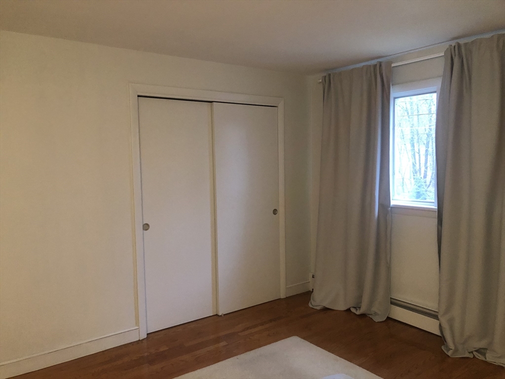 15 Sycamore Road Wakefield, MA 01880 - Photo 20 of 39 a view of an empty room with wooden floor