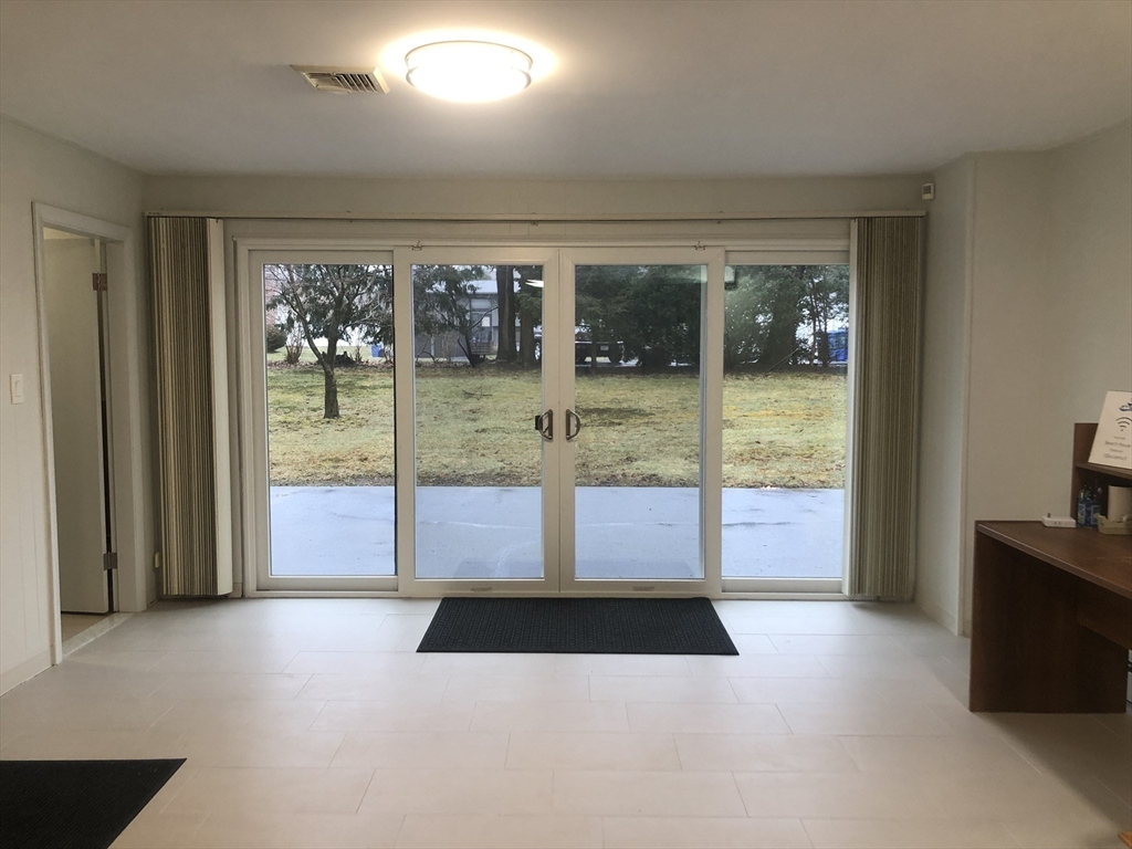 15 Sycamore Road Wakefield, MA 01880 - Photo 23 of 39 a view of an entryway with a floor to ceiling window
