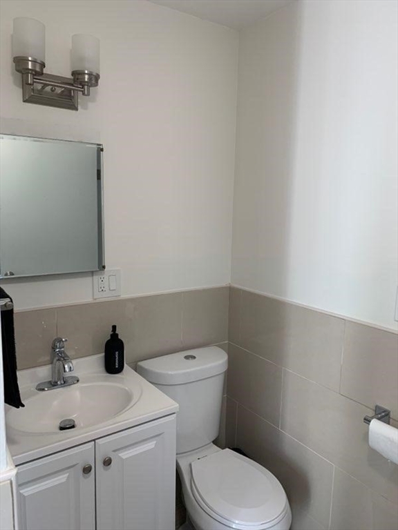 15 Sycamore Road Wakefield, MA 01880 - Photo 25 of 39 a white toilet sitting next to a bathroom sink