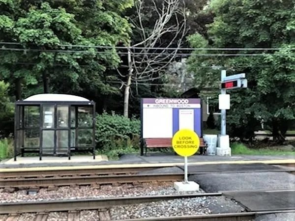 a street sign on a sidewalk next to a road