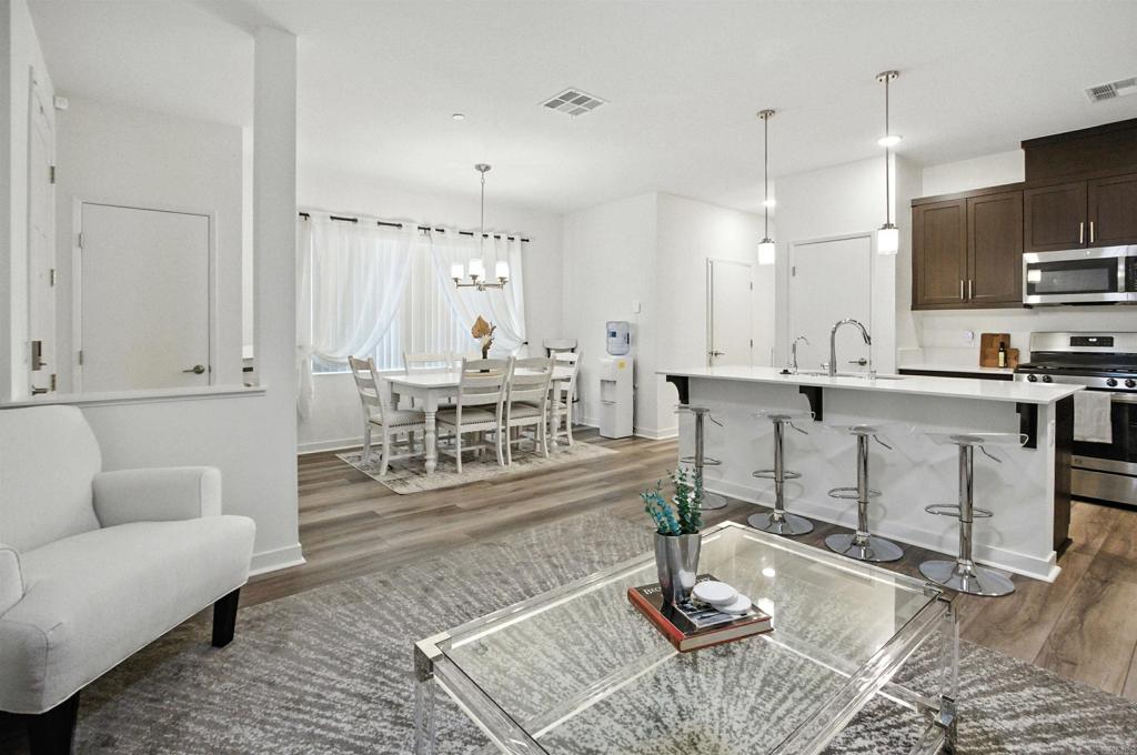 332 Seedling Way Fallbrook, CA 92028 - Photo 12 of 37 a living room with kitchen island furniture and a wooden floor